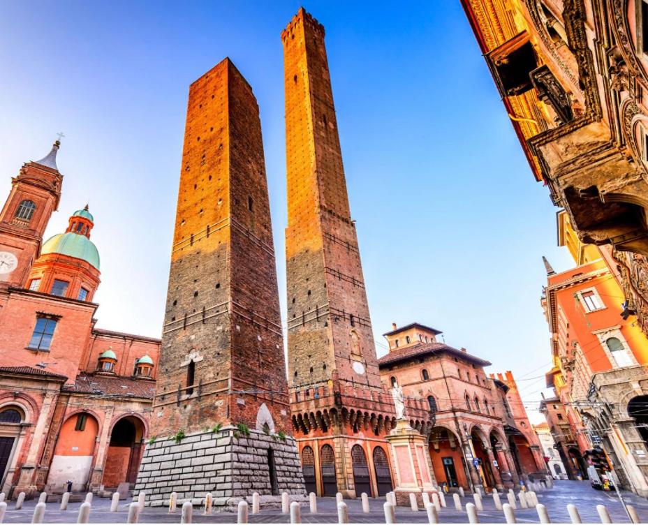 two tall towers in front of a building at Ranzani 8 in Bologna