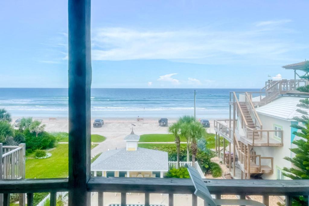 a view of the beach from the balcony of a condo at Ocean Vue in New Smyrna Beach