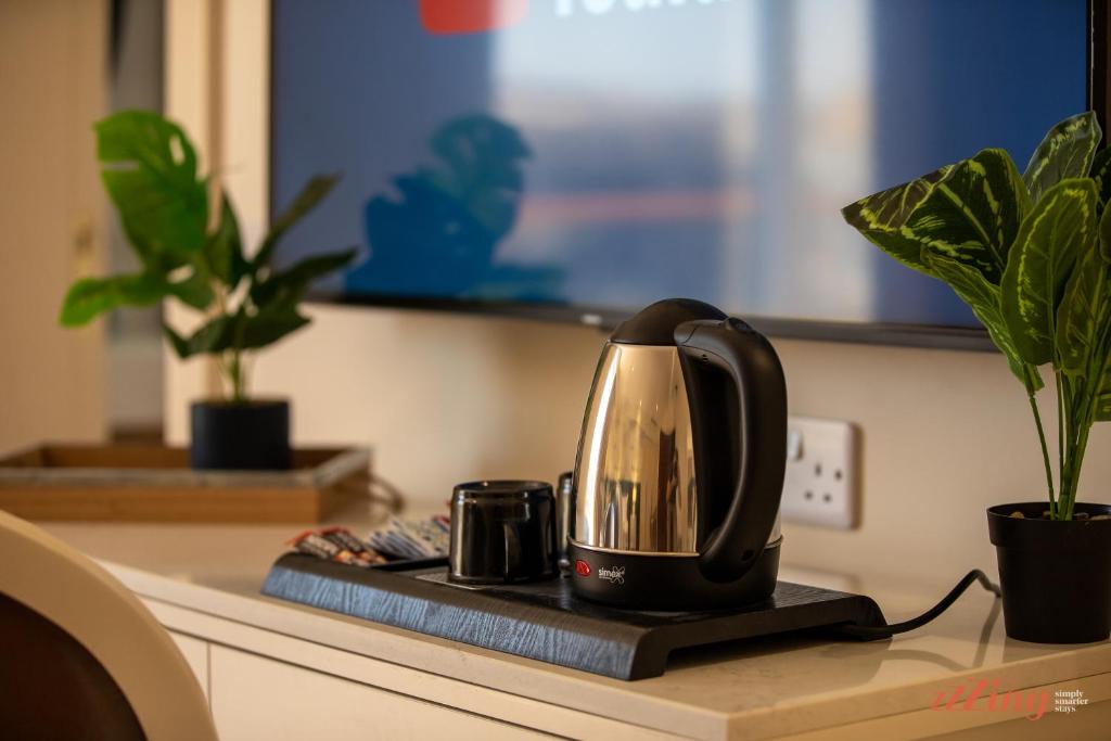 a coffee maker sitting on a kitchen counter with plants at El Doris Boutique Living in Marsaskala