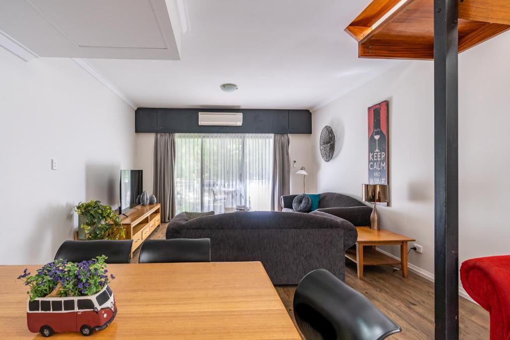 a living room with a couch and a table at Forestview Apartment Margaret River in Margaret River Town