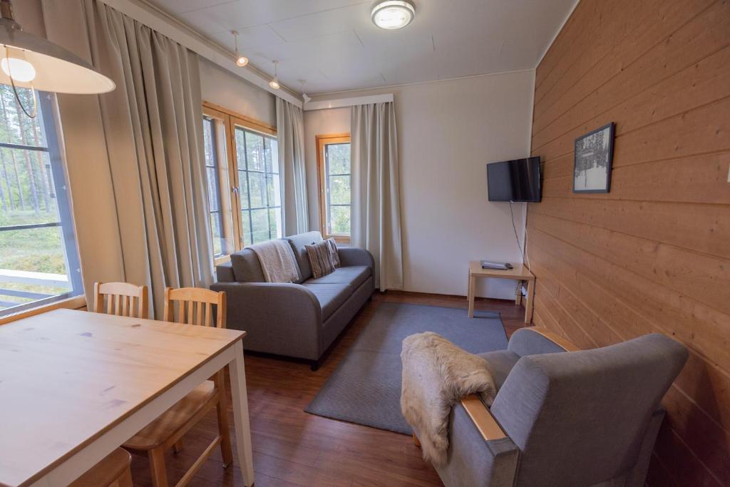 a living room with a couch and a table at Sallainen Cottages in Salla
