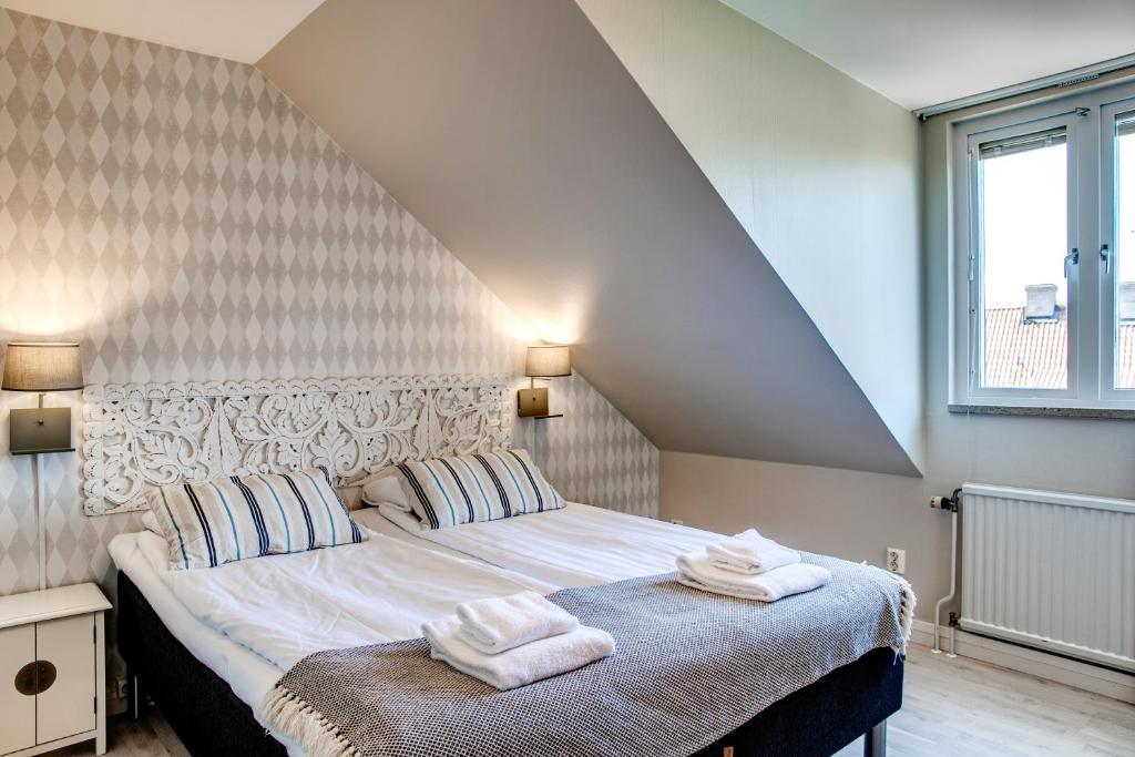 Postel nebo postele na pokoji v ubytování Hotell Lindgården