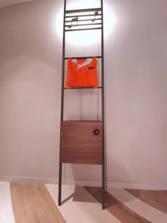 a bunk bed with an orange bag on a shelf at OLAH Poshtel - Taichung Station in Taichung