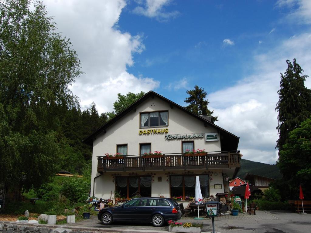 a building with a car parked in front of it at Gasthaus Rehwinkel in Titisee-Neustadt