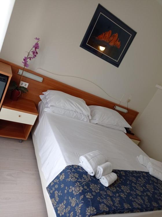 Postel nebo postele na pokoji v ubytování Hotel Verona