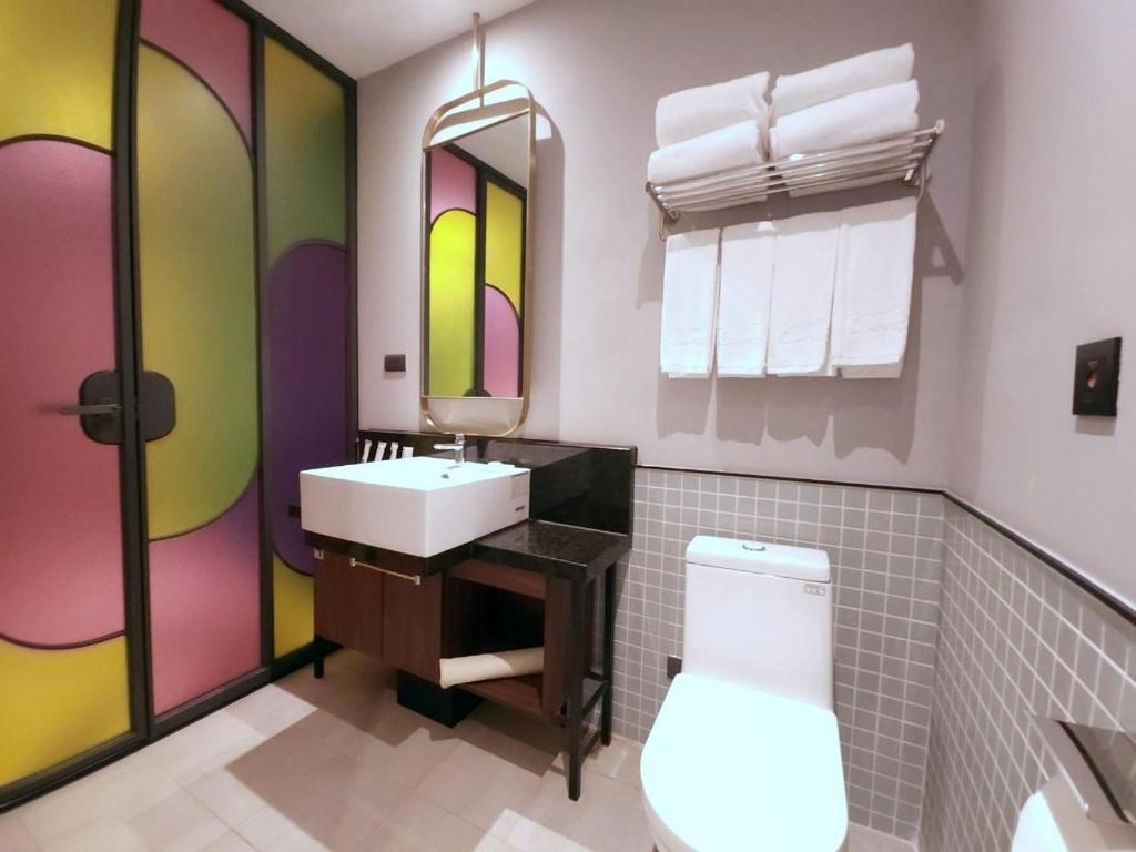 a bathroom with a sink and a toilet at OLAH Poshtel - Taichung Station in Taichung