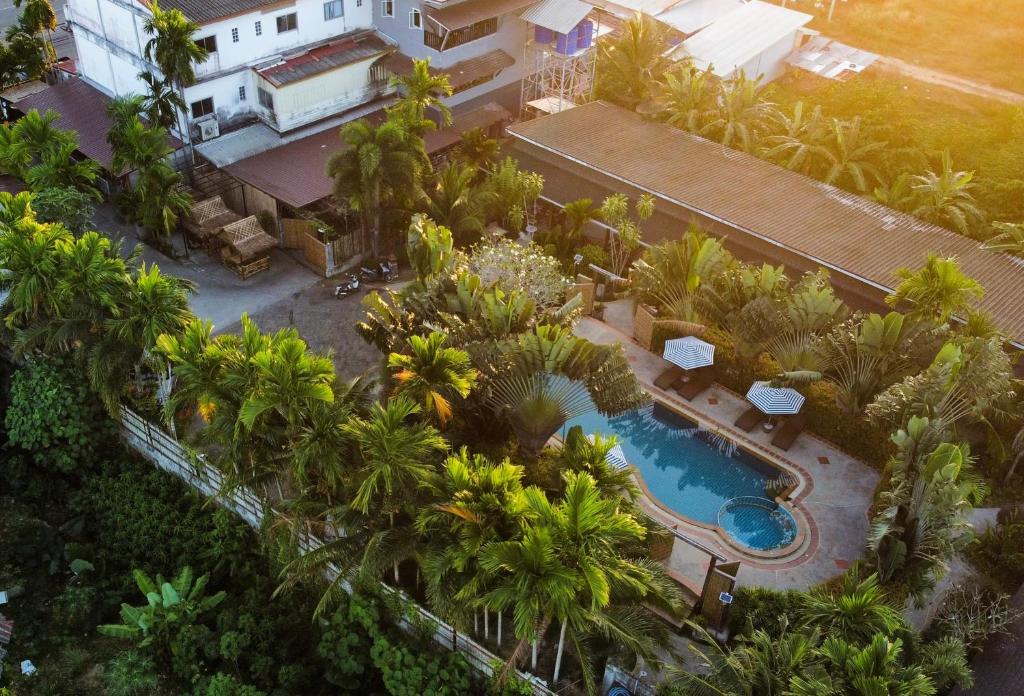 an aerial view of a resort with a swimming pool and palm trees at Phuvara Boutique Aonang in Ao Nang Beach