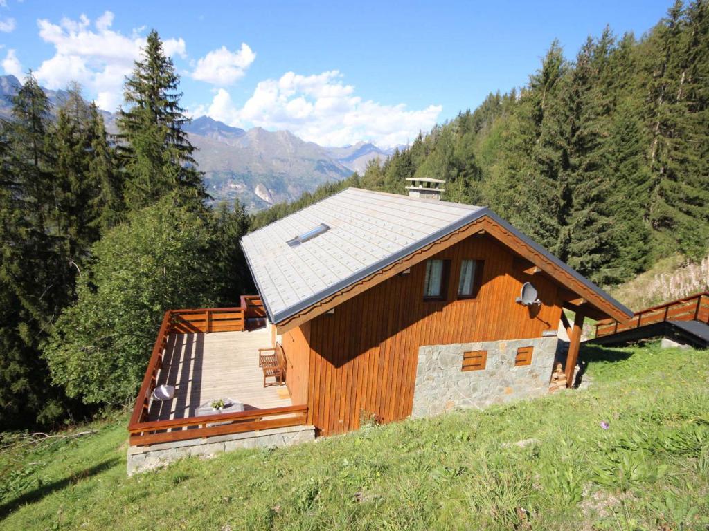 a wooden house on a hill in a field at Chalet Landry, 5 pièces, 12 personnes - FR-1-411-545 in Landry