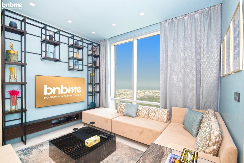 a living room with a couch and a tv at bnbmehomes - High-floor Skyscraper - Sea View - 4801 in Dubai