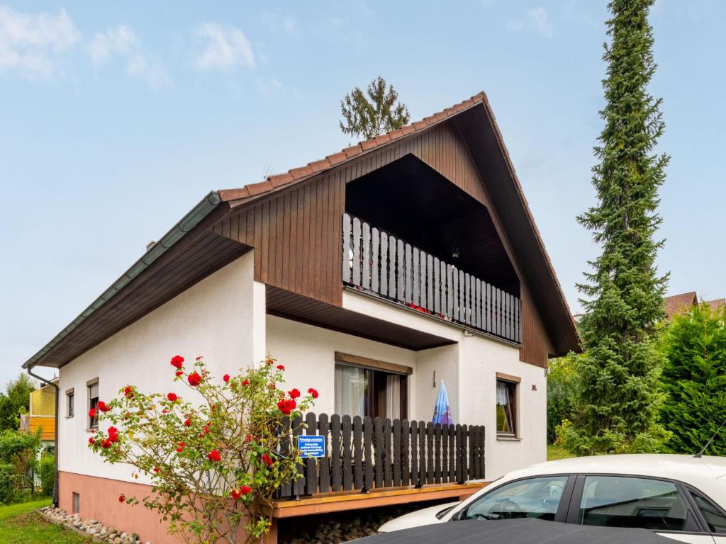 a small house with a balcony and a car at Apartment Erica-1 by Interhome in Überlingen