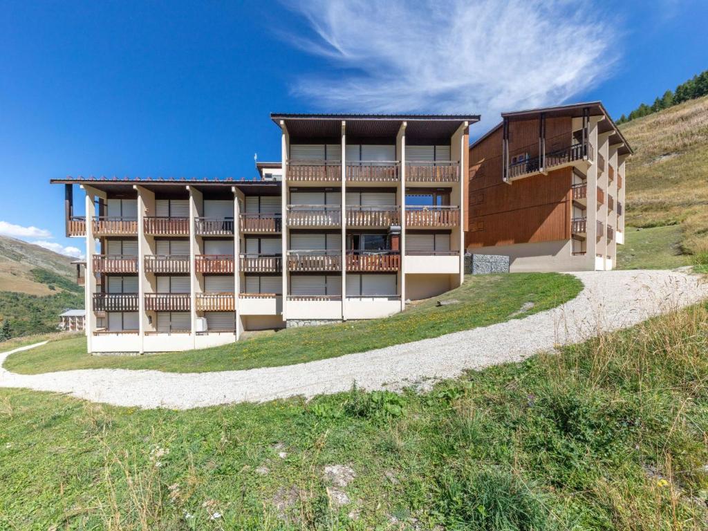 a building on the side of a hill at Apartment Asters 318 Bâtiment A1 by Interhome in Les Menuires
