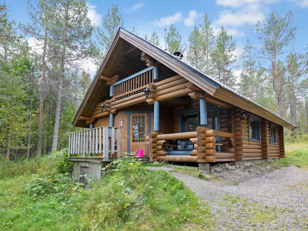 a log cabin in the woods with a porch at Holiday Home Iltatähti by Interhome in Kirpistö