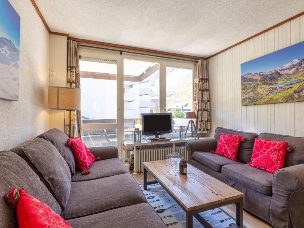 a living room with two couches and a table at Apartment Le Pramecou-11 by Interhome in Tignes