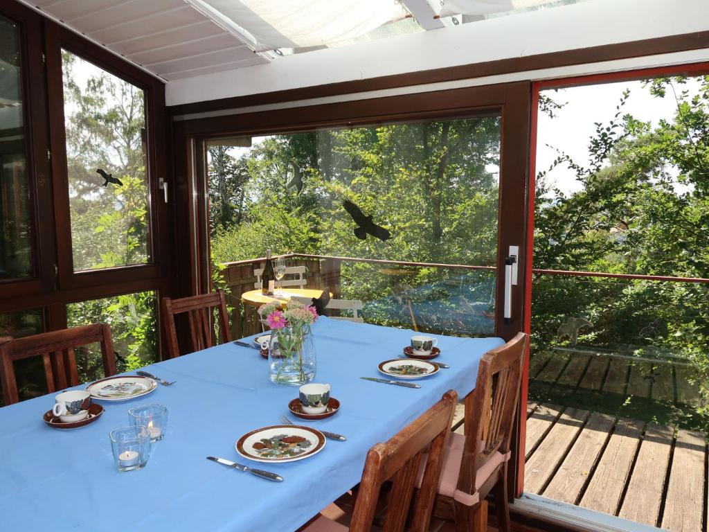 a dining room with a table and a large window at Holiday Home Clobes in Unshausen