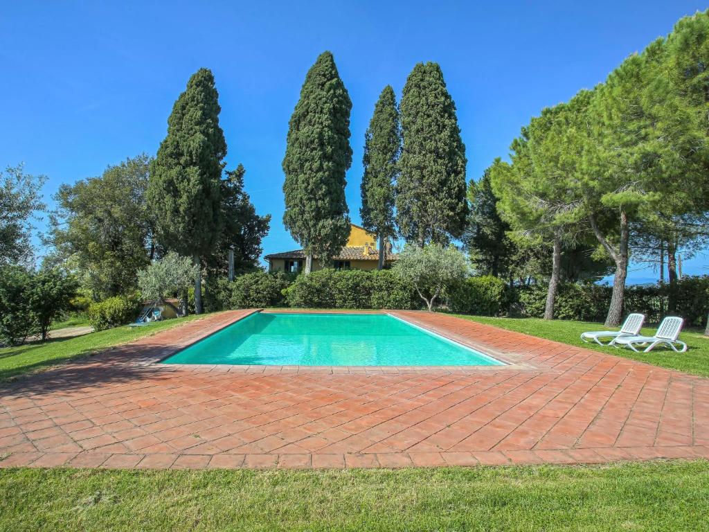 a swimming pool in a yard with trees at Apartment Campiglia-1 by Interhome in Tavarnelle in Val di Pesa