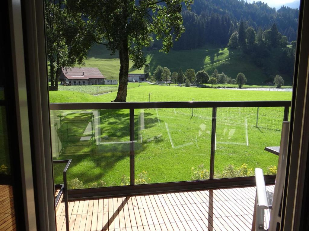 a view of a field from the window of a house at Apartment Erlenrain Wohnung 911 by Interhome in Engelberg