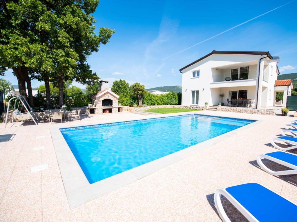 a villa with a swimming pool and a house at Holiday Home Villa Maria by Interhome in Donji Proložac