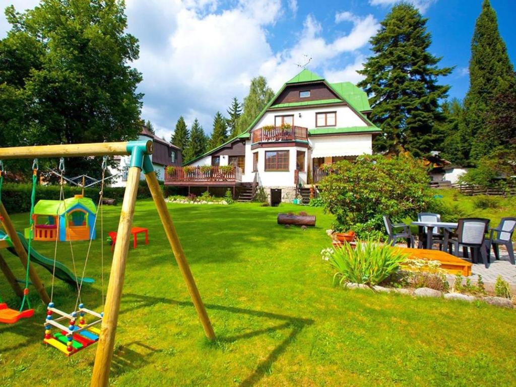 a house with a yard with a playground at Apartment Rieger 3 by Interhome in Harrachov