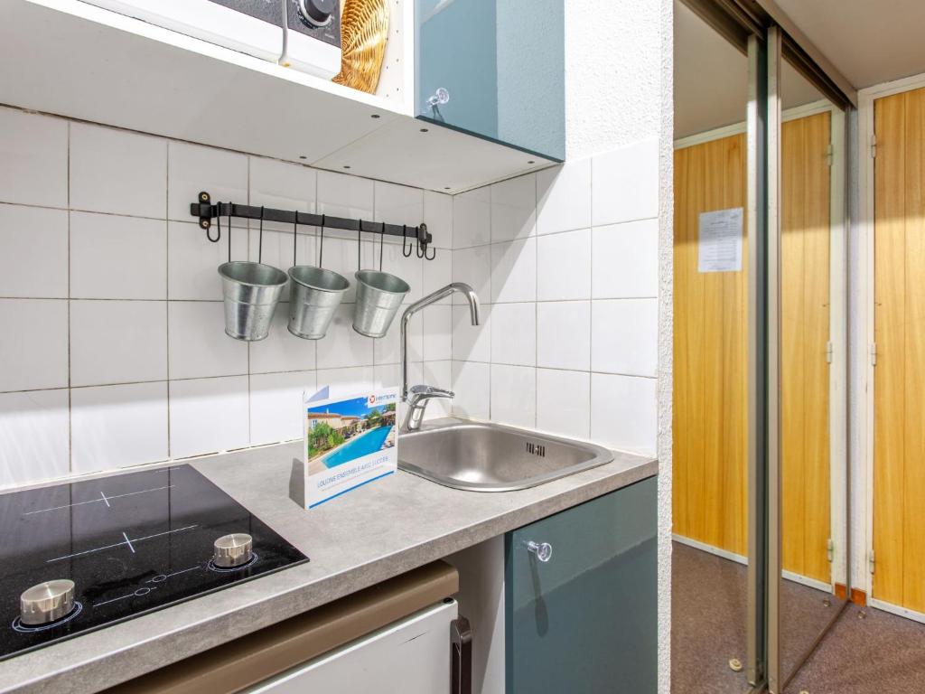 a kitchen with a sink and some cups on the wall at Studio Rond Point des Pistes-19 by Interhome in Tignes
