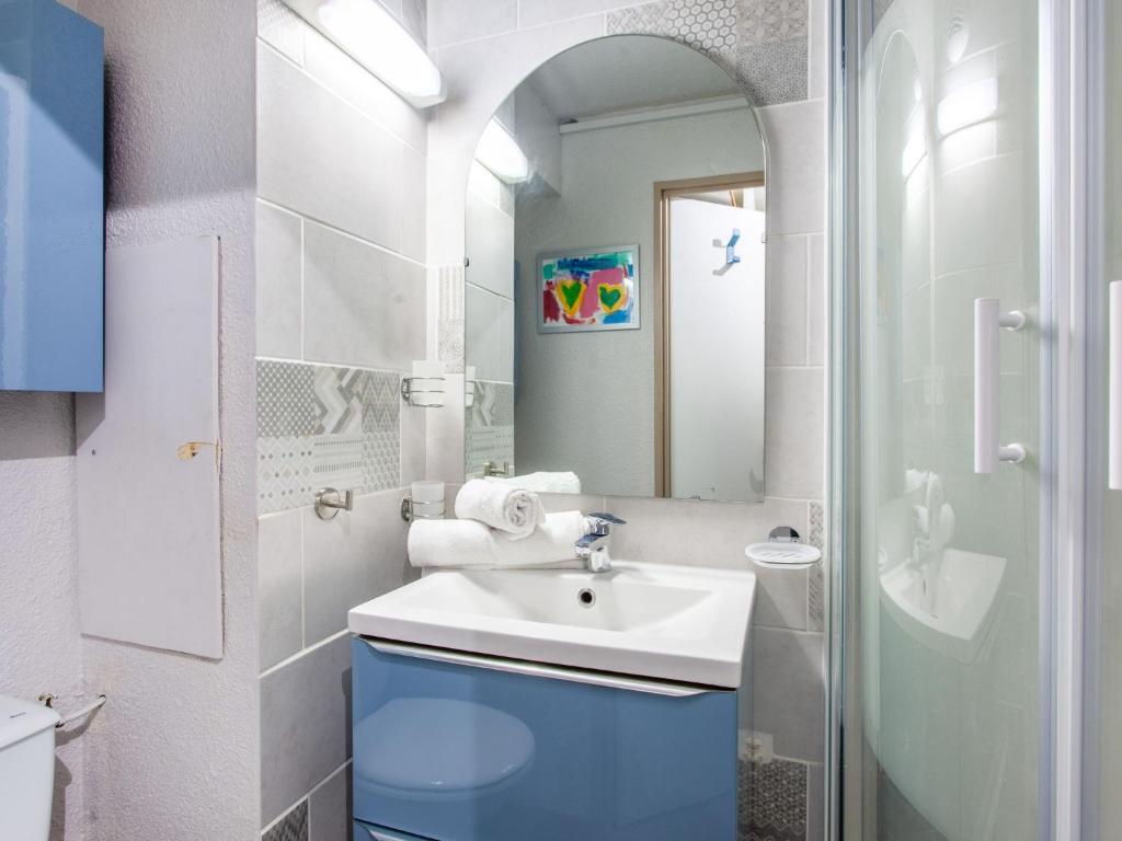 a bathroom with a sink and a mirror at Studio Rond Point des Pistes-19 by Interhome in Tignes