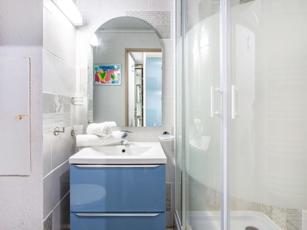 a bathroom with a blue sink and a shower at Studio Rond Point des Pistes-19 by Interhome in Tignes