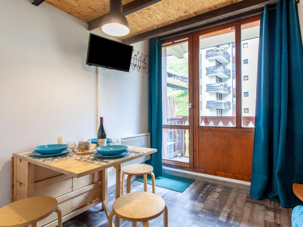 a dining room with a table and chairs and a window at Studio Rond Point des Pistes-19 by Interhome in Tignes