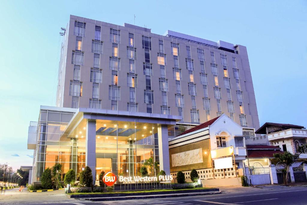 a building with a stop sign in front of it at Best Western Plus Coco Palu in Palu