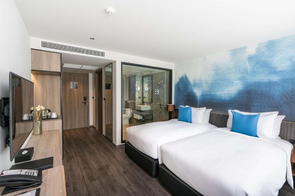 Postel nebo postele na pokoji v ubytování Best Western Plus Nexen Pattaya