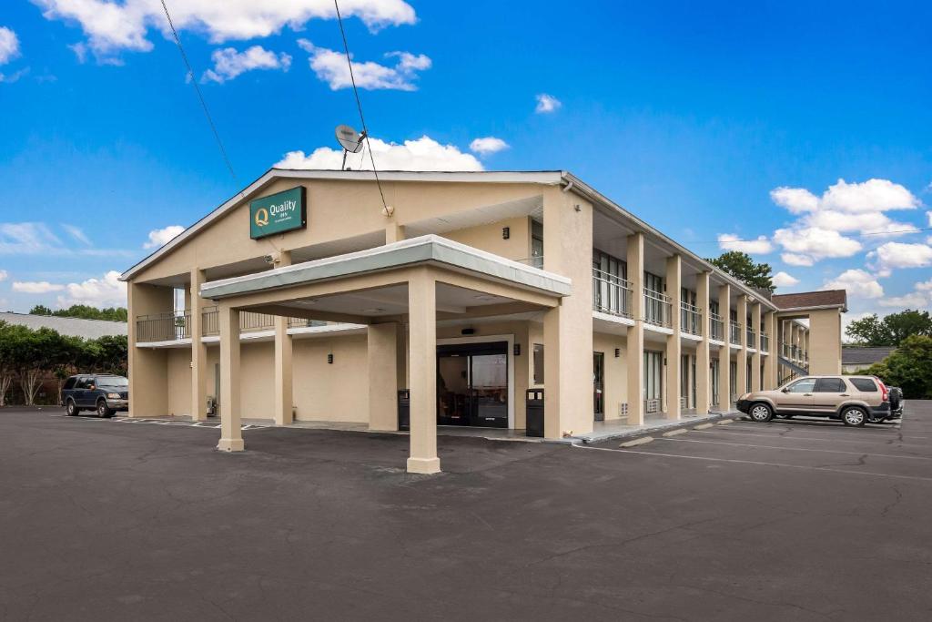 a building with a parking lot in front of it at Quality Inn in Gastonia