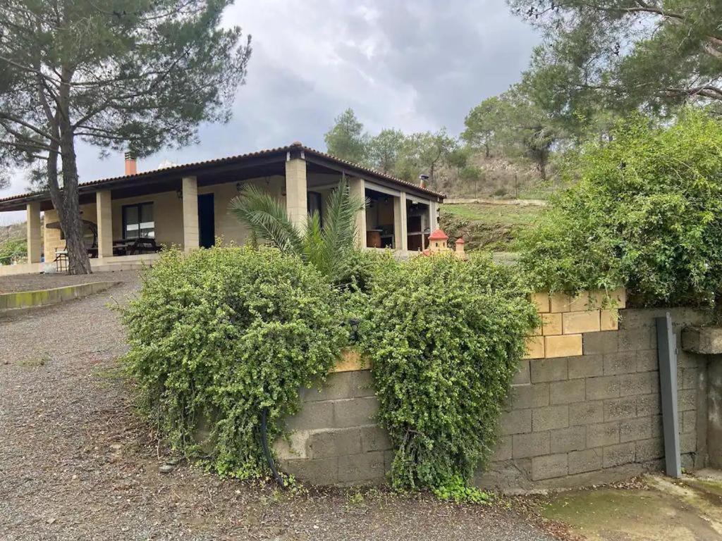 a house with bushes in front of it at Stavros Country House in Siá