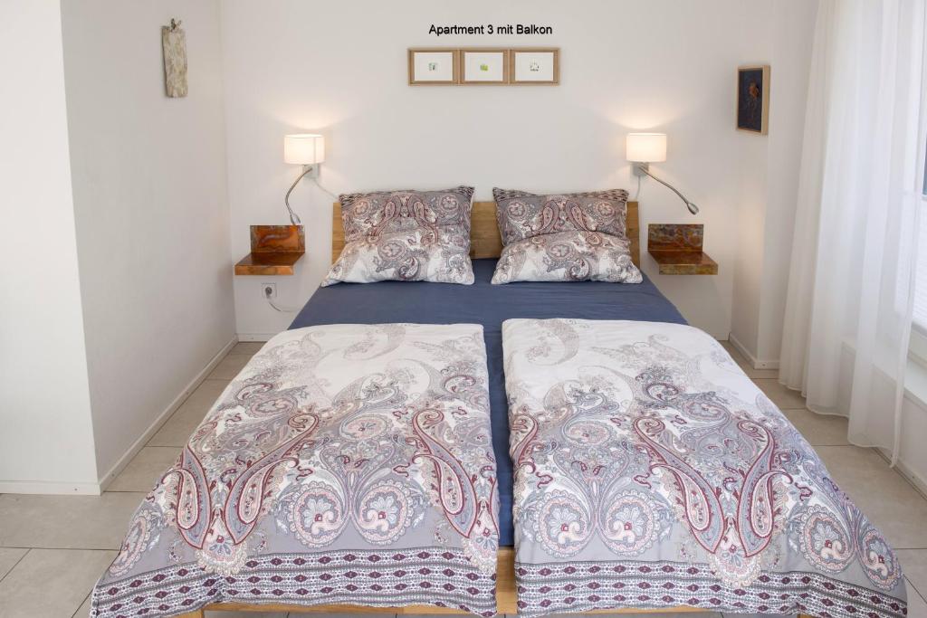 a bed in a bedroom with two pillows on it at Ferienwohnungen am Theater Freiburg in Freiburg im Breisgau