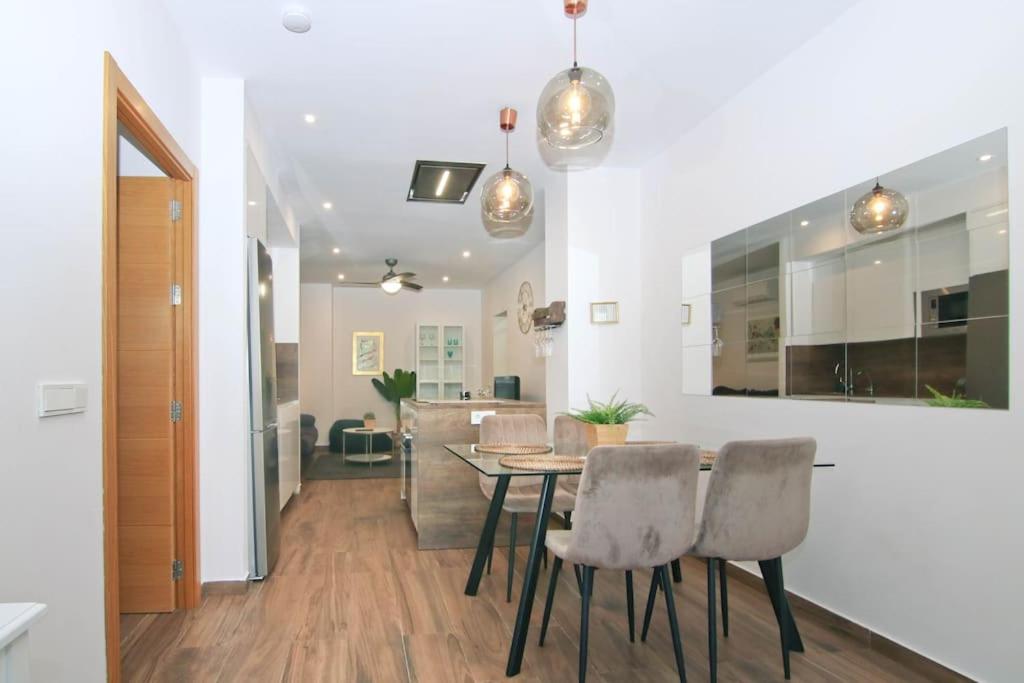 a dining room with a table and chairs at Loft Miramar in Fuengirola