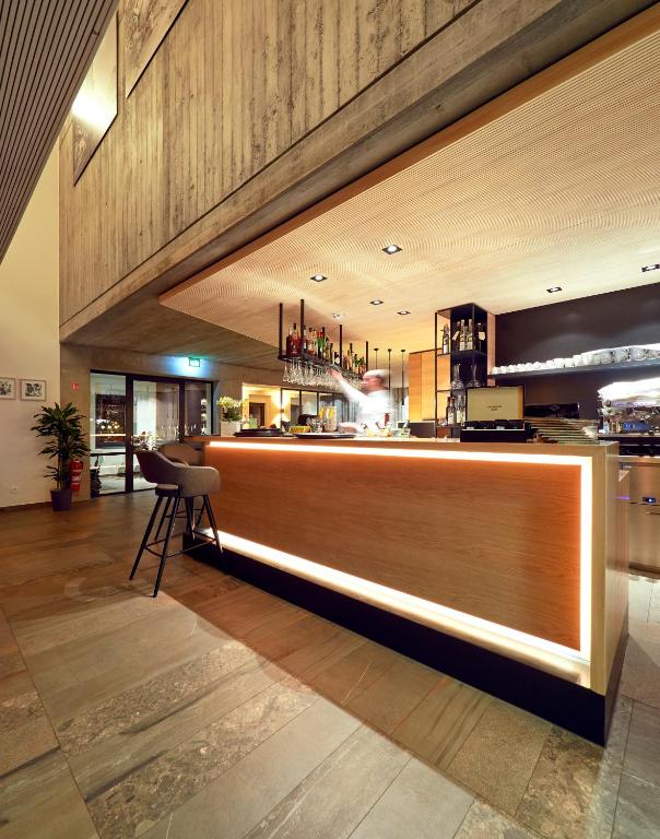 a kitchen with a bar in the middle of a room at Hostellerie Stafelter in Walferdange