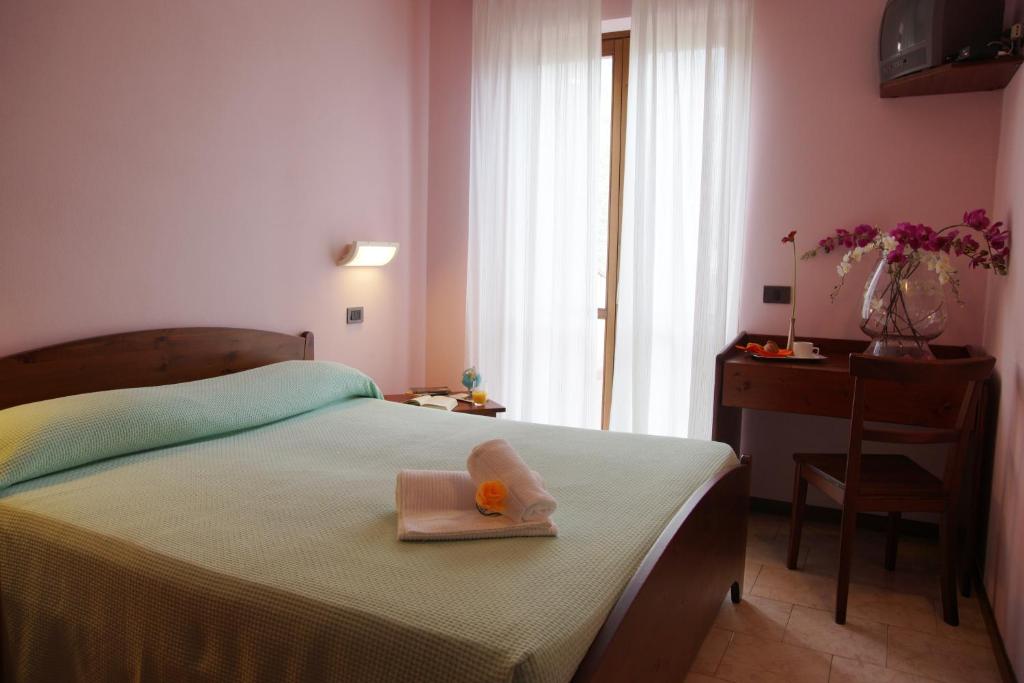 Posteľ alebo postele v izbe v ubytovaní Hotel Garnì Al Poggio