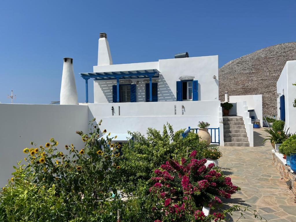 a white house with two towers on a hill at Cycladic house in rural surrounding 2 in Amorgos