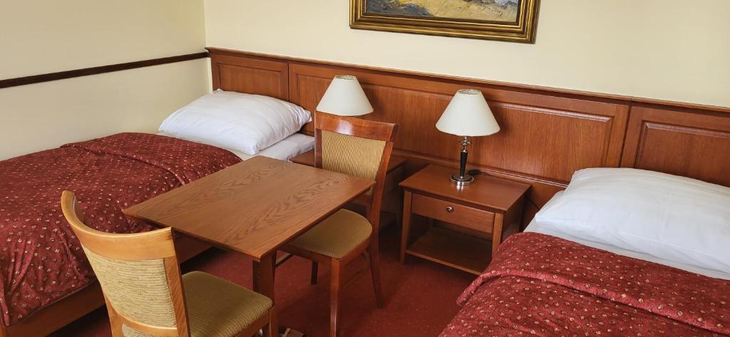 Postel nebo postele na pokoji v ubytování Hotel Matyšák