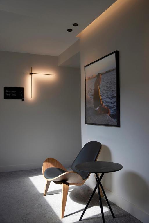 a room with a chair and a picture on the wall at Teight Hotel in Thessaloniki