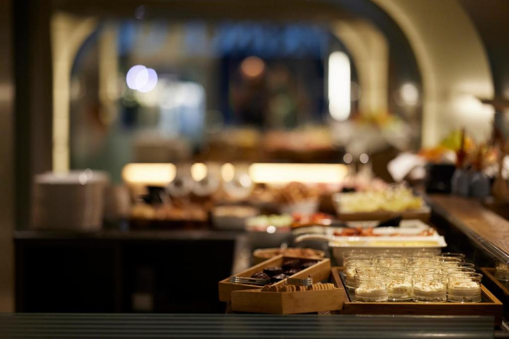 a buffet line with plates of food and drinks at Teight Hotel in Thessaloniki