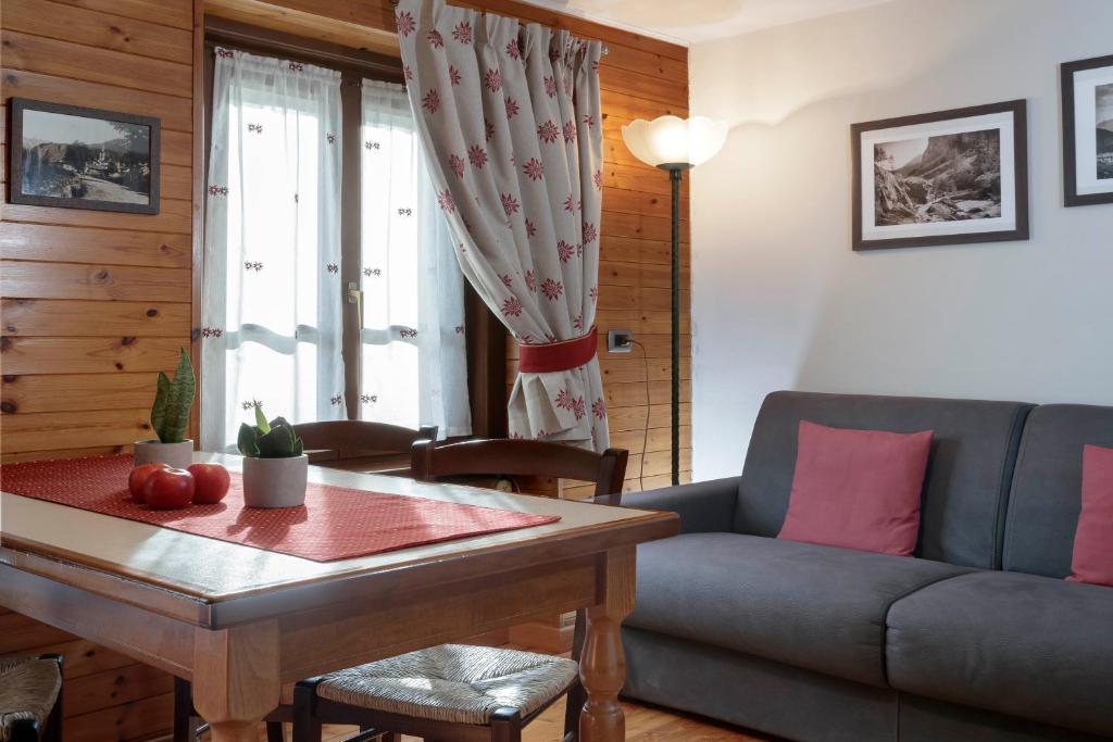 a living room with a couch and a table at HelloChalet - Maison Maquignaz with boot-warmer, 100m skibus in Valtournenche