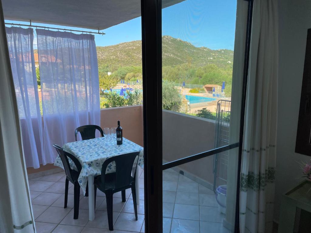 a table and chairs in a balcony with a view at Sardegna Beach Cala Reale in Santa Marinella