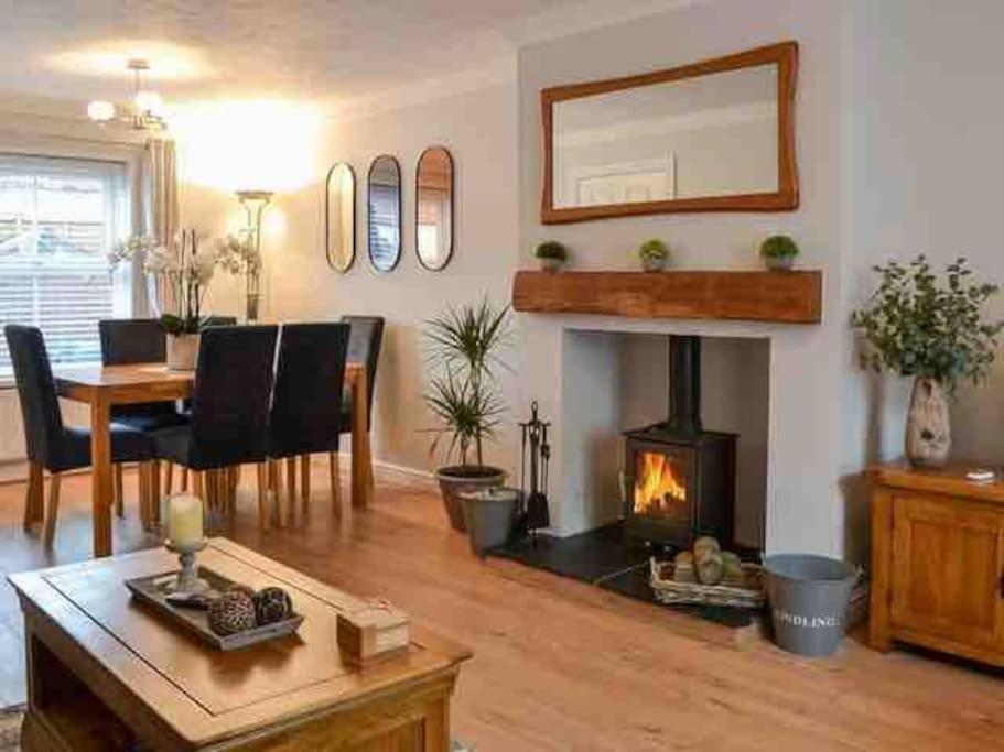 a living room with a table and a fireplace at The Haven in Hornsea Town Centre in Hornsea