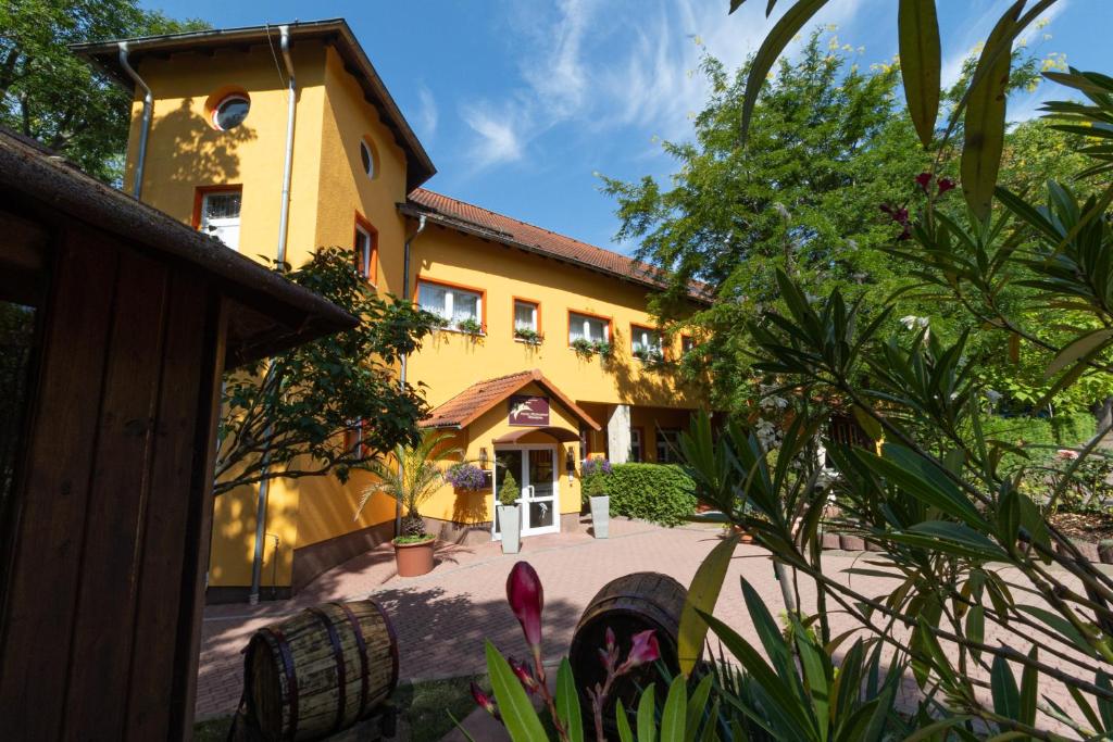 a large yellow building with a building at Hotel-Restaurant Weinberg in Artern