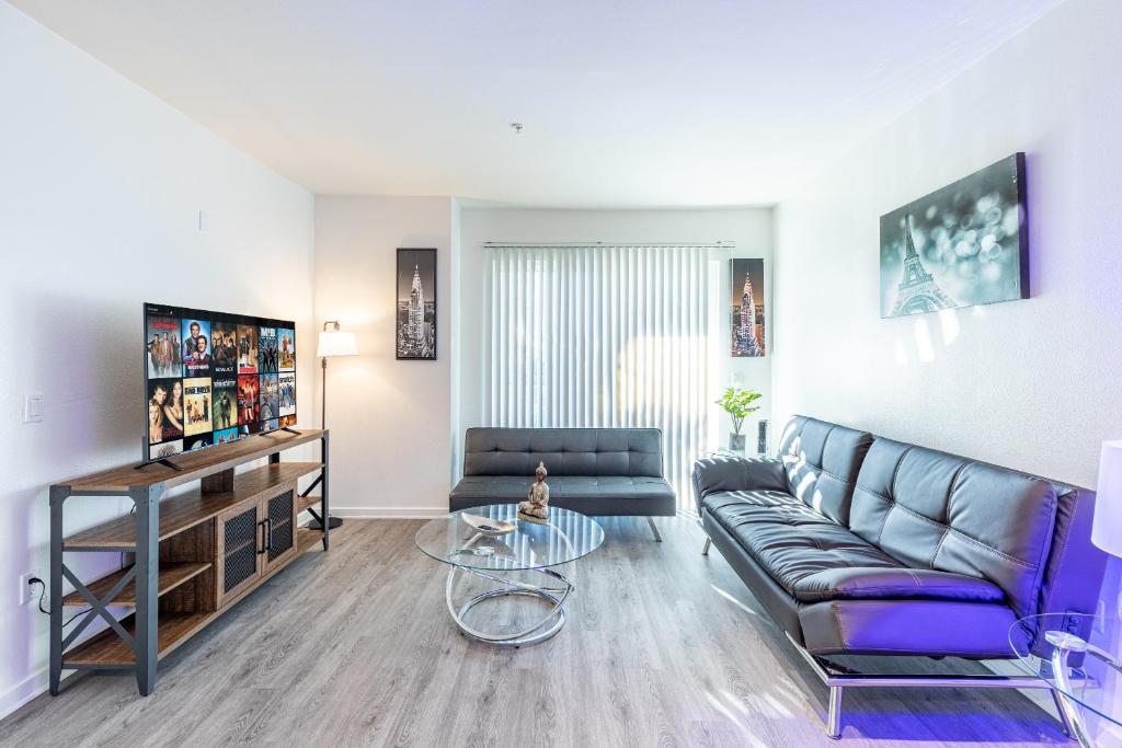 a living room with a couch and a table at Heaven on Hollywood Furnished Apartments in Los Angeles