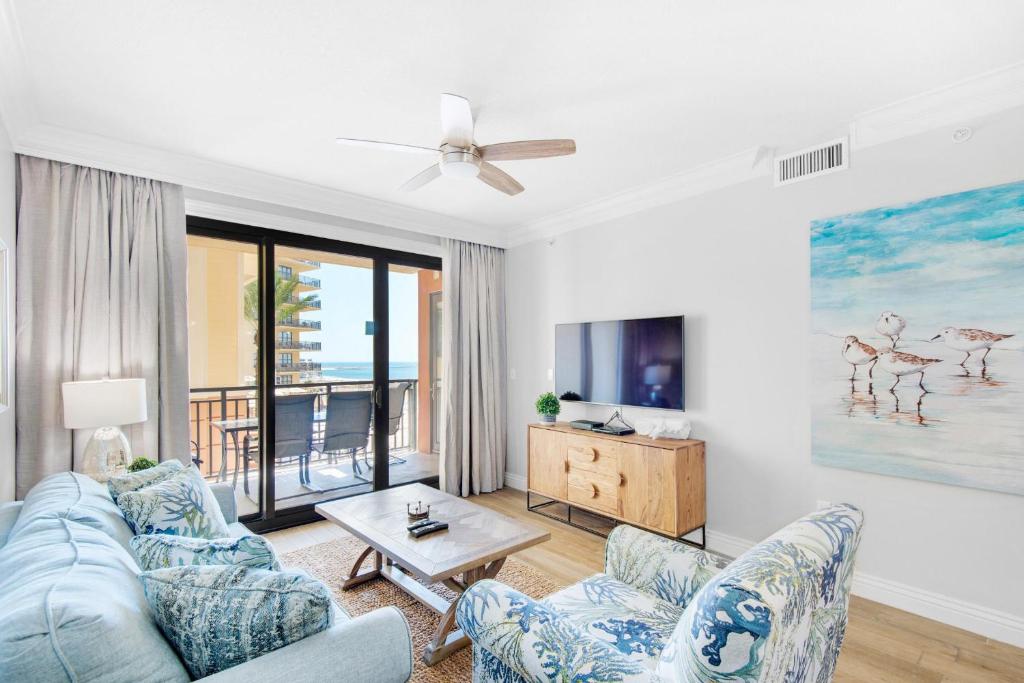 a living room with a couch and a tv at Emerald Grande W222- Rexford's BEACH Retreat in Destin