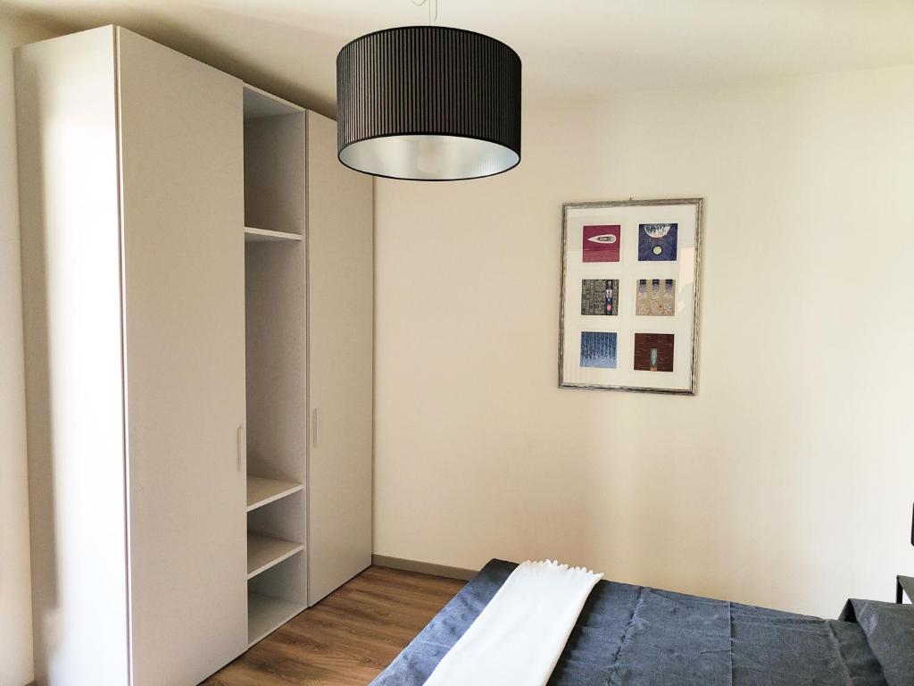 a bedroom with a bed and a closet at Domus Acaja in Pinerolo