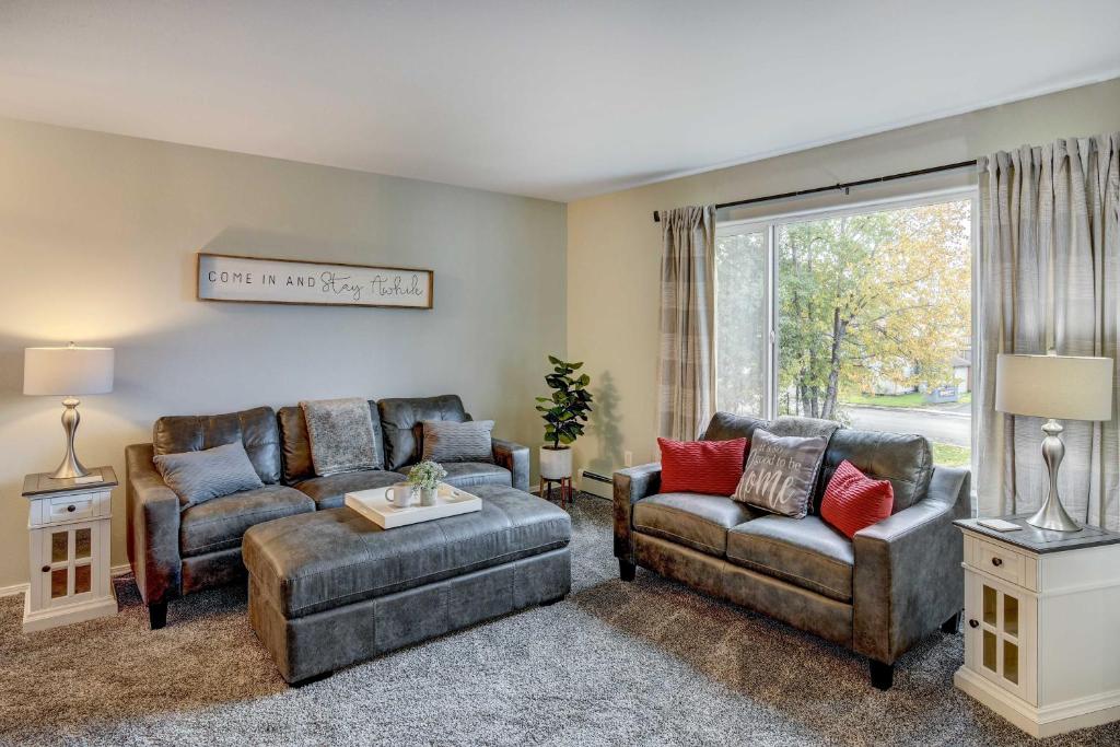 a living room with two couches and a window at Anchorage Retreat Less Than 5 Mi to Hilltop Ski Area! in Anchorage