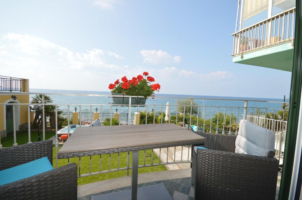 a balcony with a table and chairs and the ocean at Residenza Marina in Riva Ligure