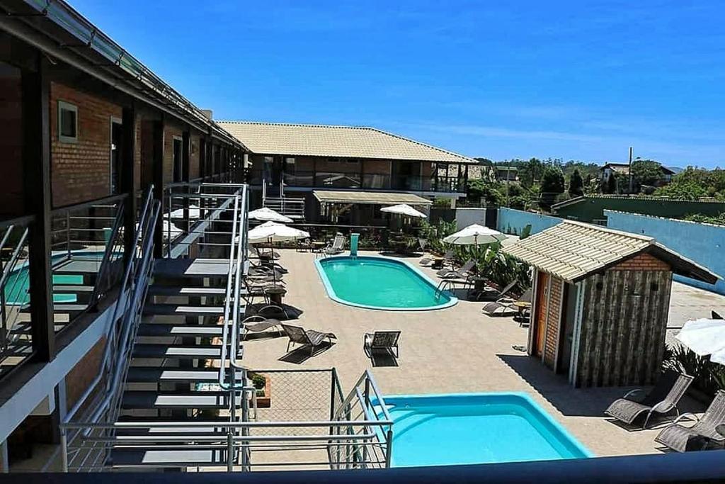 arial view of a resort with two swimming pools at Pousada Moçamba Dunas Beach in Florianópolis