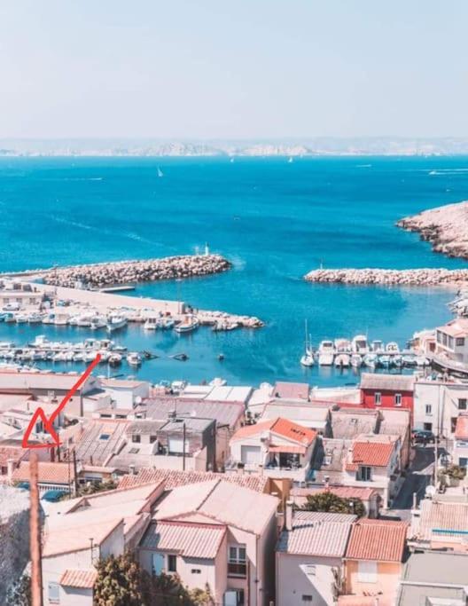 a view of a harbor with boats in the water at Maison de village à 35 m du bord de mer in Marseille
