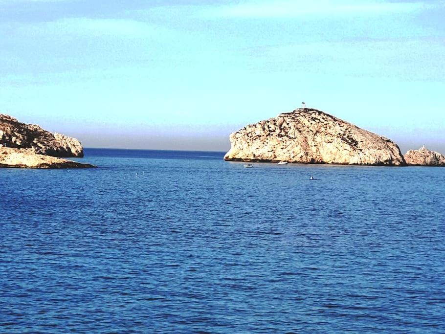a large body of water with two islands in it at Maison de village à 35 m du bord de mer in Marseille